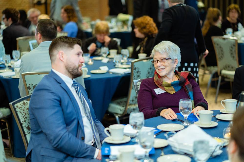 Two guests speaking at Scholarship Dinner 2019
